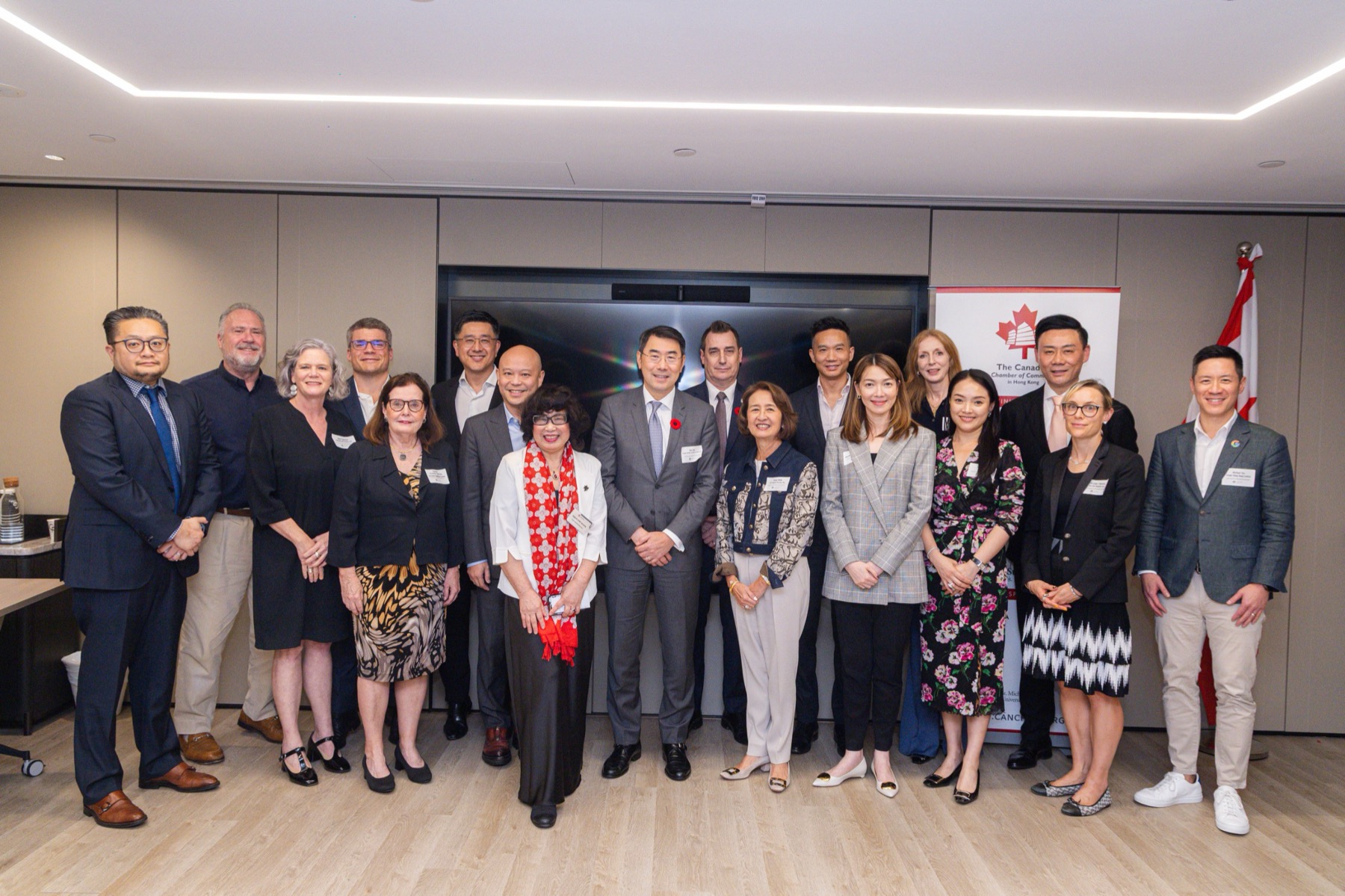 The chamber’s leadership in a Hong Kong boardroom, beneath the Canadian flag